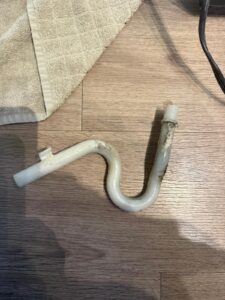 Clogged drain hose removed during appliance repair