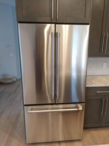 Installed a stainless steel French-door refrigerator with a bottom freezer drawer