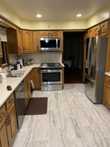 Installed a stainless steel gas range and over-the-range microwave in an updated kitchen layout